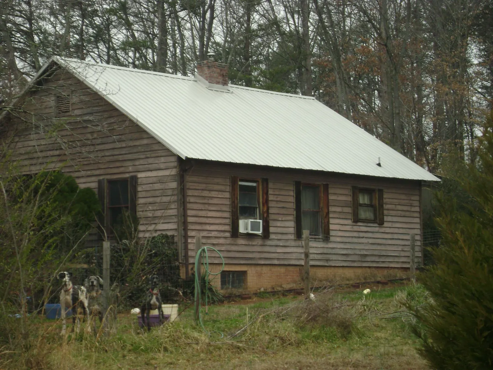 White metal roof on an old wood sided farmhouse, from a Asphalt Shingle Roof Repair job in Imperial